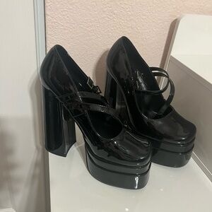Woman’s black glossy platform shoes